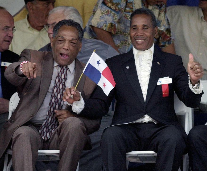 FILE - In this June 10, 2001, file photo, International Boxing Hall of Fame inductees Sugar Ramos of Mexico, front left, and Ismael Laguna of Panama, gesture during induction ceremonies in Canastota, N.Y. Ramos, the Cuban featherweight champion whose fists led to two deaths in the ring, has died in Mexico City. He was 75. The World Boxing Council said he died Sunday, Sept. 3, 2017, of cancer. (AP Photo/Kevin Rivoli, File)