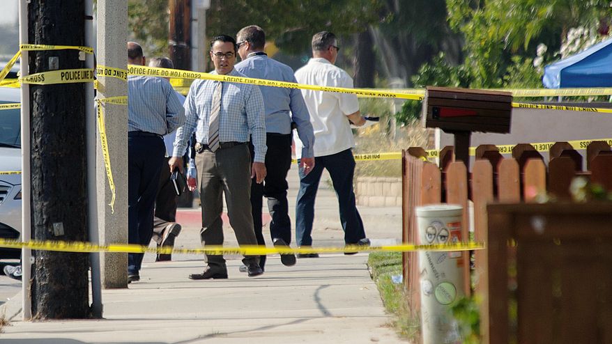 A detective stops for a moment to look again at the scene where two officers and one suspect were hospitalized after a call for a man with a knife turned into an officer-involved shooting in Huntington Beach, Calif., Thursday, Sept. 7, 2017. (Ken Steinhardt/The Orange County Register via AP)