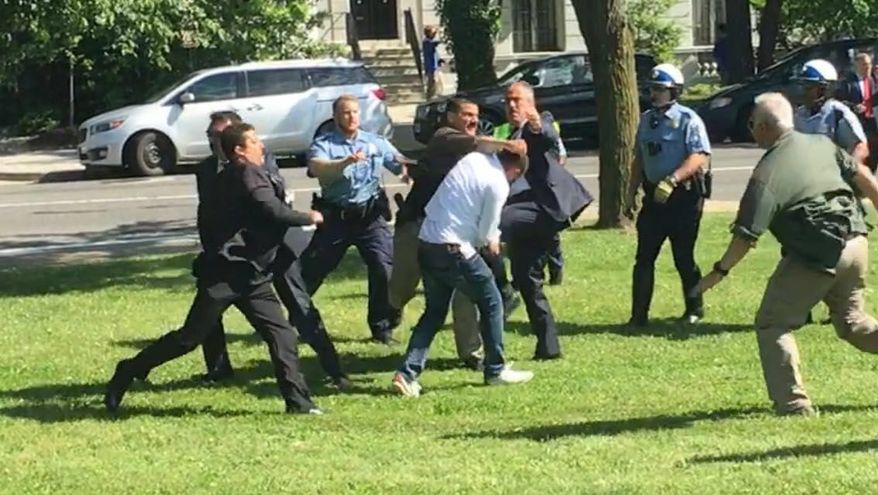 A pro-Kurdish protestor is surrounded and beaten by Turkish security officials after a peaceful protest against Turkish President Recep Tayipp Erdogan turned violent outside the Turkish Ambassador&#39;s Residence in D.C. in May. (Courtesy Mehmet Tankan)