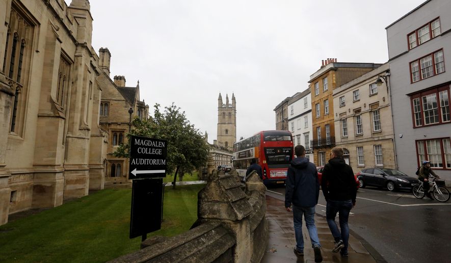 In this Sunday, Sept. 3, 2017 photo, people walk around Oxford University&#x27;s campus in Oxford, England.  The number of EU applicants to British universities fell this year for the first time since 2012, as EU nationals remain uncertain of what their rights will be in post-Brexit Britain. (AP Photo/Caroline Spiezio)