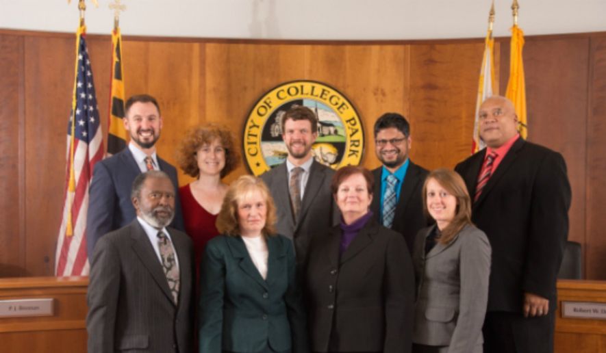 The mayor (back row, center) and city council of College Park, Md., are shown here in a photo from the city&#39;s website. The D.C. suburb, host to the University of Maryland, is weighing changing its charter to allow noncitizens to vote, but may first ask city voters to weigh in by nonbinding referendum. (CollegeParkMD.gov) [http://collegeparkmd.gov/government/mayor_and_council/index.php]