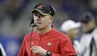 FILE - In this Dec. 26, 2016, file photo, Maryland coach DJ Durkin walks the sideline during the first half of the Quick Lane Bowl NCAA college football game against Boston College in Detroit. Maryland plays Towson this week. (AP Photo/Carlos Osorio, File)