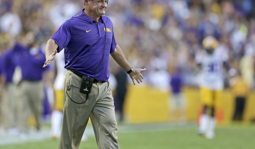 LSU head coach Ed Orgeron smiles after his team scored their first touchdown against Chattanooga during the first half of an NCAA college football game in Baton Rouge, La., Saturday, Sept. 9, 2017. (AP Photo/Rusty Costanza)