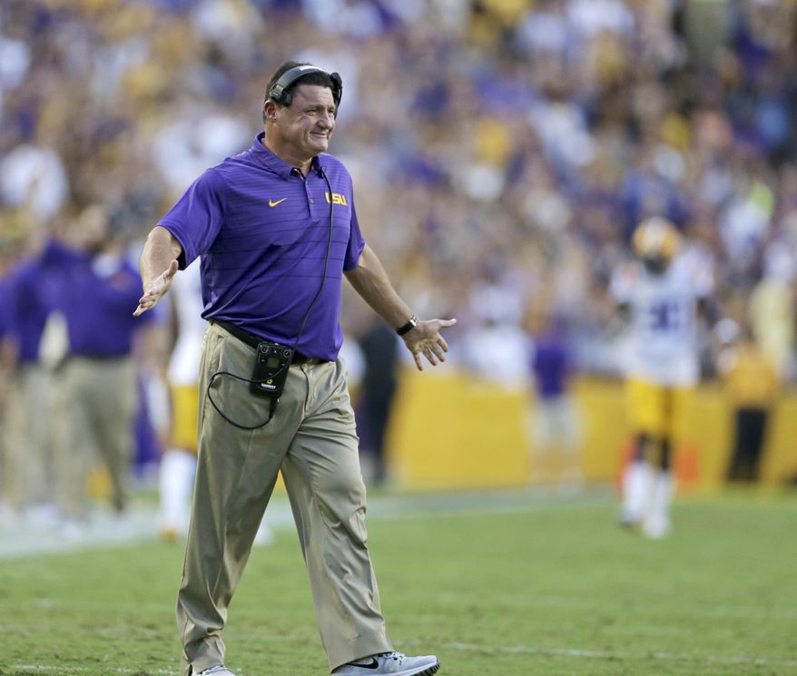 LSU head coach Ed Orgeron smiles after his team scored their first touchdown against Chattanooga during the first half of an NCAA college football game in Baton Rouge, La., Saturday, Sept. 9, 2017. (AP Photo/Rusty Costanza)