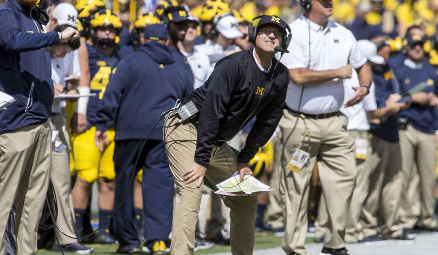 Michigan head coach Jim Harbaugh looks up at the scoreboard from the sideline in the second quarter of an NCAA college football game against Cincinnati in Ann Arbor, Mich., Saturday, Sept. 9, 2017. (AP Photo/Tony Ding)