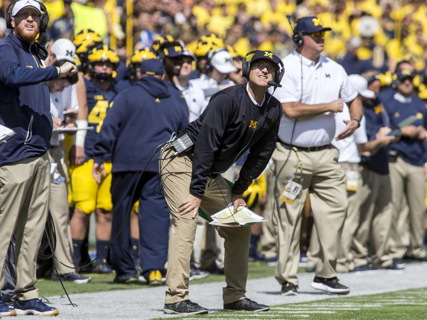 Michigan head coach Jim Harbaugh looks up at the scoreboard from the sideline in the second quarter of an NCAA college football game against Cincinnati in Ann Arbor, Mich., Saturday, Sept. 9, 2017. (AP Photo/Tony Ding)