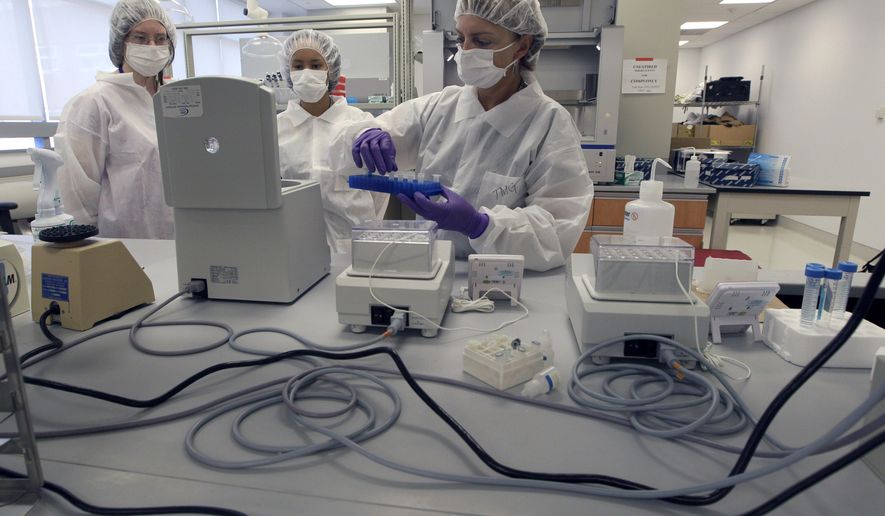 FILE- In this Aug. 10, 2011 file photo Tatyana Gryazeva, right, a criminalist at the Office of Chief Medical Examiner, instructs Lache Rossouw, center, a visiting scientist from South Africa, and Kelsey Baker, an intern, on extracting DNA at a training lab of the New York City Office of Chief Medical Examiner's Forensic Biology Lab in New York. A technique for analyzing DNA evidence developed by the laboratory has come under fire amid questions about its reliability. (AP Photo/Mary Altaffer, File)