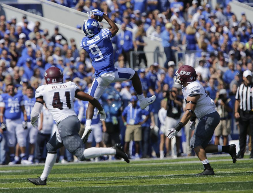 Kentucky's Garrett Johnson catches a first down pass in front of Eastern Kentucky's Eric Reed, left, and Jeffrey Canady during the first half of an NCAA college football game Saturday, Sept. 9, 2017, in Lexington, Ky. (AP Photo/David Stephenson)