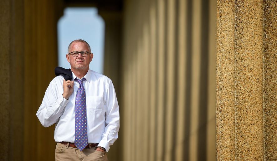Dr. Stephen Loyd, Tennessee’s assistant commissioner overseeing the substance abuse services department, poses for a portrait at the Parthenon in Centennial Park in Nashville, Tenn., on Aug. 30, 2017. At one time in his life, Loyd battled a 100-pain-pills-a-day habit after medical school. (Lacy Atkins /The Tennessean via AP)
