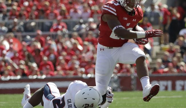 Wisconsin's Jonathan Taylor breaks away from Florida Atlantic's Zyon Gilbert during the second half of an NCAA college football game Saturday, Sept. 9, 2017, in Madison, Wis. Wisconsin won 31-14. (AP Photo/Morry Gash)
