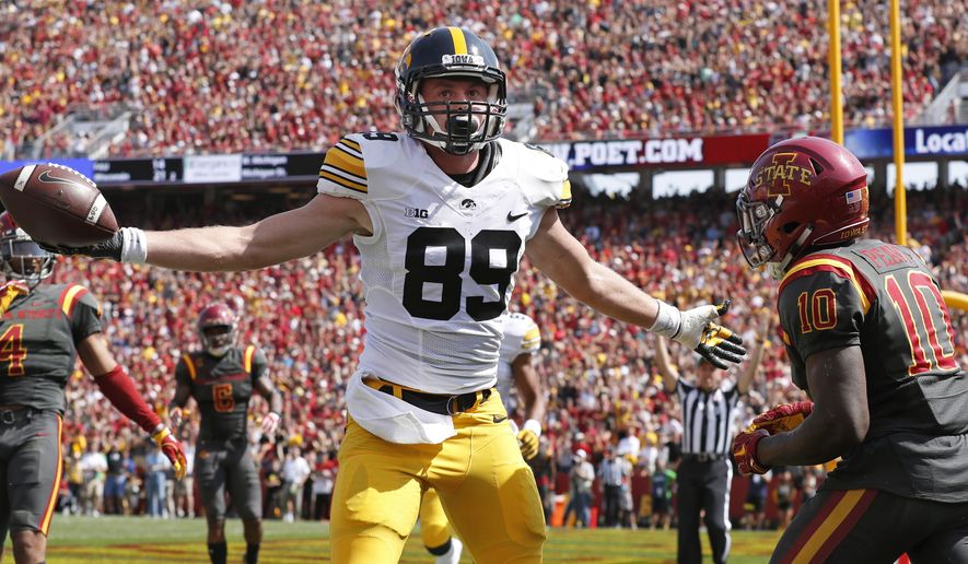 Iowa wide receiver Matt VandeBerg (89) celebrates in front of Iowa State defensive back Brian Peavy (10) after catching a 17-yard touchdown pass during the first half of an NCAA college football game, Saturday, Sept. 9, 2017, in Ames, Iowa. (AP Photo/Charlie Neibergall)
