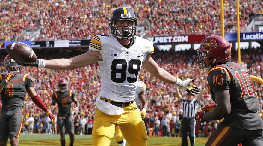 Iowa wide receiver Matt VandeBerg (89) celebrates in front of Iowa State defensive back Brian Peavy (10) after catching a 17-yard touchdown pass during the first half of an NCAA college football game, Saturday, Sept. 9, 2017, in Ames, Iowa. (AP Photo/Charlie Neibergall)