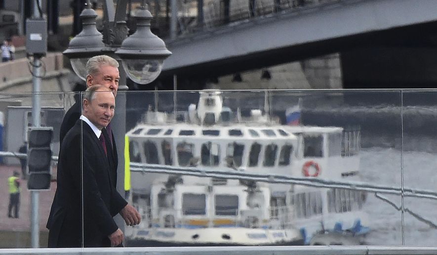 Russian President Vladimir Putin, right, and Moscow Mayor Sergei Sobyanin visit the Zaryadye Park in Moscow, Russia, Saturday, Sept. 9, 2017. With a visit from President Putin, Moscow has inaugurated an innovative 32-acre (13-hectare) Zaryadye Park that mimics features of Russia's landscape on land where a notoriously unsightly hotel once sprawled, coming as part of observances commemorating Moscow's 870th anniversary. (Vasily Maximov, Pool Photo via AP)