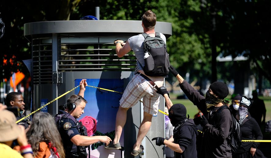A pro-Trump supporter tries to get his hat back in Portland, Ore., on September 10, 2017, after he was confronted by antifascist protesters gathering against a rally by right-aligned Patriot Prayer supporters led by Joey Gibson. Only a few Patriot Prayer members showed up and police used pepper spray after protesters pushed down a barrier separating the groups. (Photo by Alex Milan Tracy)(Sipa via AP Images)