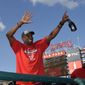 Washington Nationals manager Dusty Baker waves to the crowd in the stands as they celebrate after clinching the National League East title after a baseball game against the Philadelphia Phillies, Sunday, Sept. 10, 2017, in Washington.(AP Photo/Nick Wass)