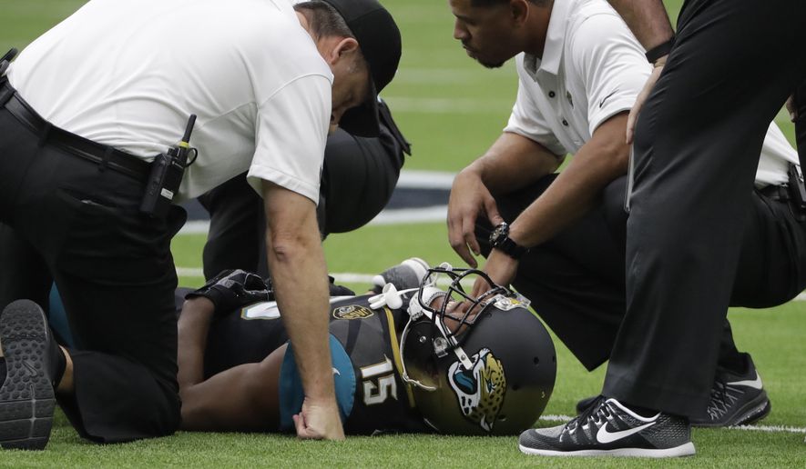 Jacksonville Jaguars wide receiver Allen Robinson (15) is tended to by medical staff after an injury while facing the Houston Texans in the first half of an NFL football game Sunday, Sept. 10, 2017, in Houston. (AP Photo/David J. Phillip)