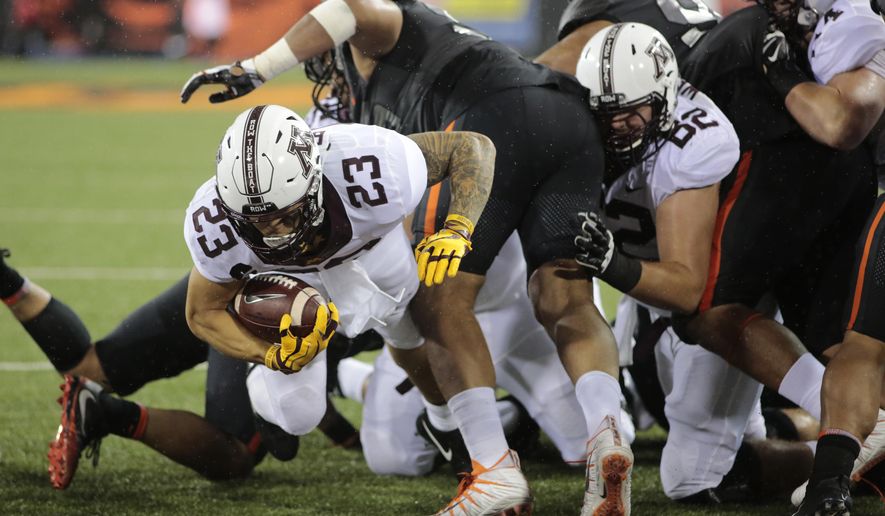 Minnesota's Shannon Brooks (23) fights his way through the Oregon State defensive line for a touchdown during the first half of an NCAA college football game in Corvallis, Ore., Saturday, Sept. 9, 2017. (AP Photo/Timothy J. Gonzalez)