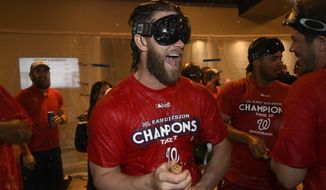 Washington Nationals&#39; Bryce Harper reacts in the locker room as the team celebrates after they clinched the National League East title after a baseball game against the Philadelphia Phillies, Sunday, Sept. 10, 2017, in Washington.(AP Photo/Nick Wass)