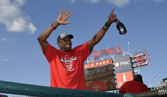 Washington Nationals manager Dusty Baker waves to the crowd in the stands as they celebrate after clinching the National League East title after a baseball game against the Philadelphia Phillies, Sunday, Sept. 10, 2017, in Washington.(AP Photo/Nick Wass)