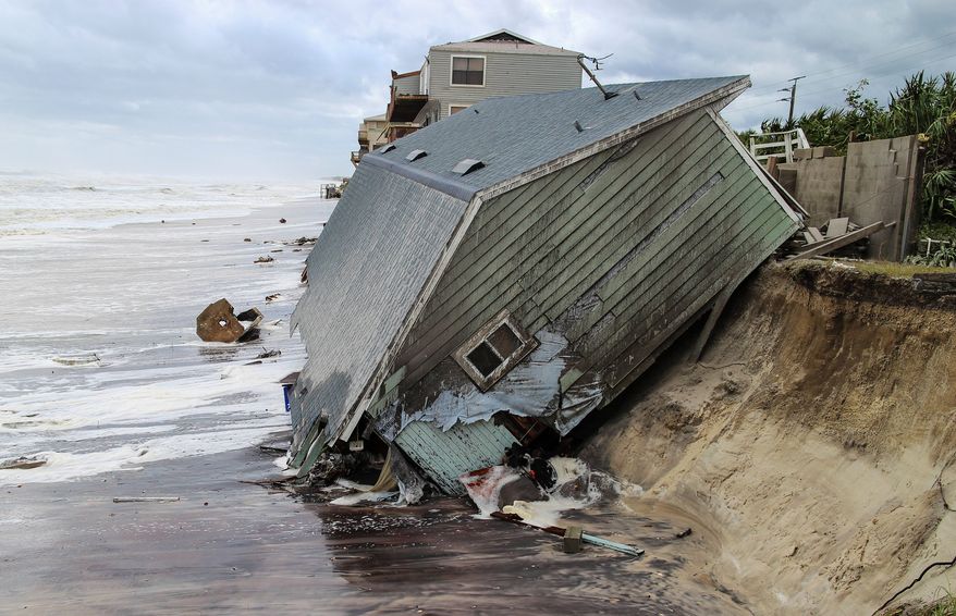A house in Florida, slid into the Atlantic Ocean on Monday while Irma, downgraded to a tropical storm, was menacing Georgia and canceling flights at the world's busiest airport in Atlanta. (Gary Lloyd McCullough/The Florida Times-Union via AP)