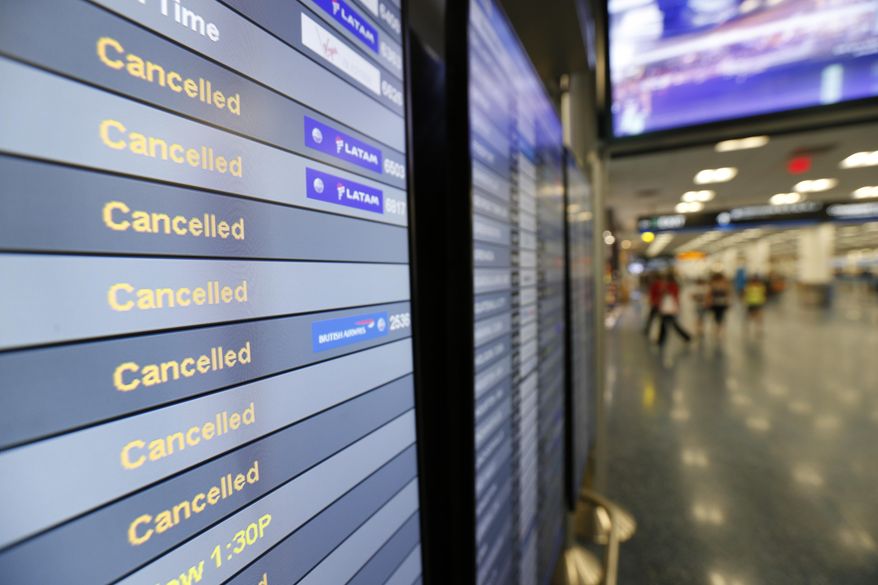 FILE - This Friday, Sept. 8, 2017, file photo, shows a monitor listing canceled flights at Miami International Airport in Miami. As of Monday, Sept. 11, 2017, airlines have canceled more flights as air travel in Florida remains grounded and Irma spins farther north. High winds have caused Delta and American to cancel many flights in Atlanta and Charlotte, N.C. Airlines hope to resume Miami flights Tuesday. (AP Photo/Wilfredo Lee, File)
