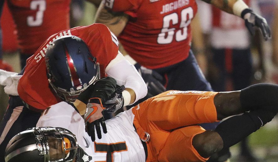 South Alabama wide receiver Sam Harris, top, tackles Oklahoma State cornerback A.J. Green, bottom, who fumbles the ball after an interception during the second half of an NCAA college football game, Friday, Sept. 8, 2017, in Mobile, Ala. South Alabama recovered the ball. Oklahoma State won 44-7. (AP Photo/Dan Anderson)