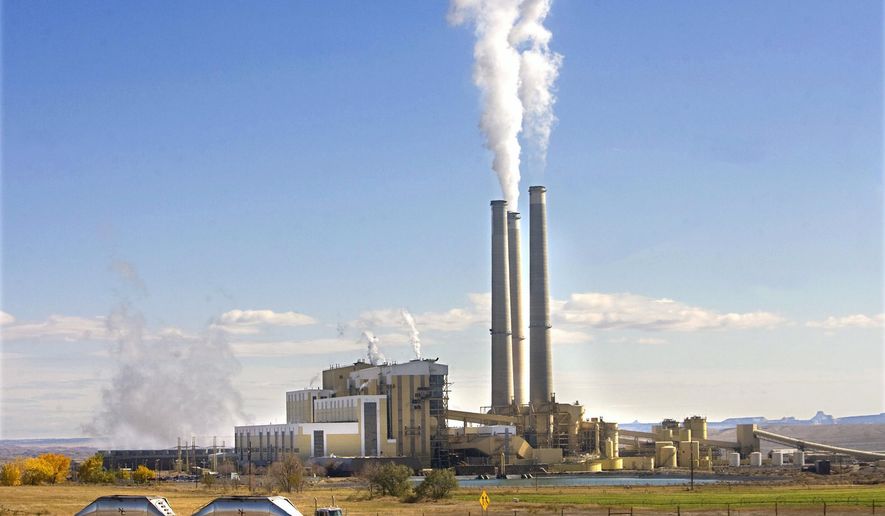 FILE - In this Oct. 23, 2009, file photo, coal trucks leave the coal-fired Hunter Power Plant just south of Castle Dale, Utah, after making a delivery. An appeals court has granted a request from President Donald Trump's administration to halt a plan for new pollution controls at Utah's oldest coal-fired power plants aimed at reducing haze near national parks. (Al Hartmann/The Salt Lake Tribune via AP, File)
