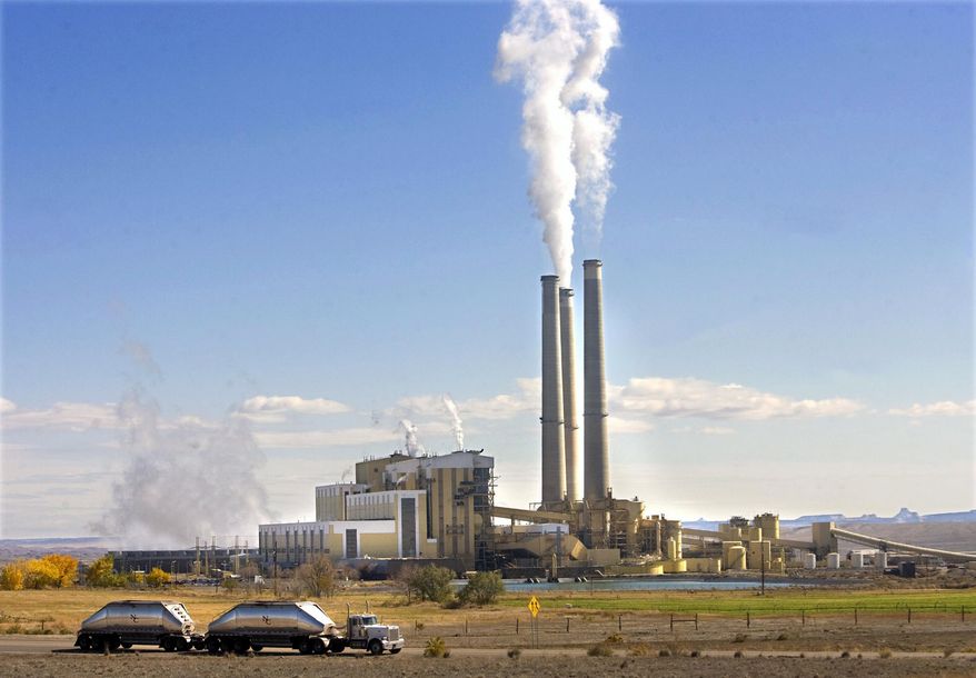 FILE - In this Oct. 23, 2009, file photo, coal trucks leave the coal-fired Hunter Power Plant just south of Castle Dale, Utah, after making a delivery. An appeals court has granted a request from President Donald Trump's administration to halt a plan for new pollution controls at Utah's oldest coal-fired power plants aimed at reducing haze near national parks. (Al Hartmann/The Salt Lake Tribune via AP, File)