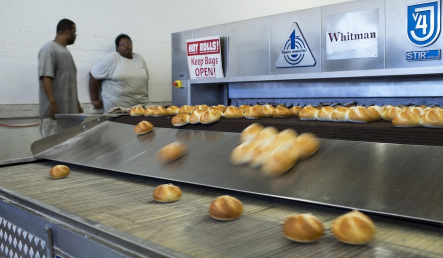 In this Wednesday, Aug. 23, 2017, photo, freshly-baked rolls come out of an oven at Del Buono's Bakery in Haddon Heights, N.J. Entrepreneur Tom Whitman saw an opportunity to marry one of South Jersey's oldest Italian bakeries and a class delicatessen when he bought the two fabled institutions. Now, Del Buono's Bakery and Carmen's are working together to bring patrons traditional sandwiches on quality rolls. Whitman says it was a way to move into the future while still caring for the legacies of two businesses. (Joe Lamberti/Camden Courier-Post via AP)