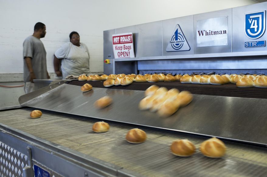 In this Wednesday, Aug. 23, 2017, photo, freshly-baked rolls come out of an oven at Del Buono's Bakery in Haddon Heights, N.J. Entrepreneur Tom Whitman saw an opportunity to marry one of South Jersey's oldest Italian bakeries and a class delicatessen when he bought the two fabled institutions. Now, Del Buono's Bakery and Carmen's are working together to bring patrons traditional sandwiches on quality rolls. Whitman says it was a way to move into the future while still caring for the legacies of two businesses. (Joe Lamberti/Camden Courier-Post via AP)