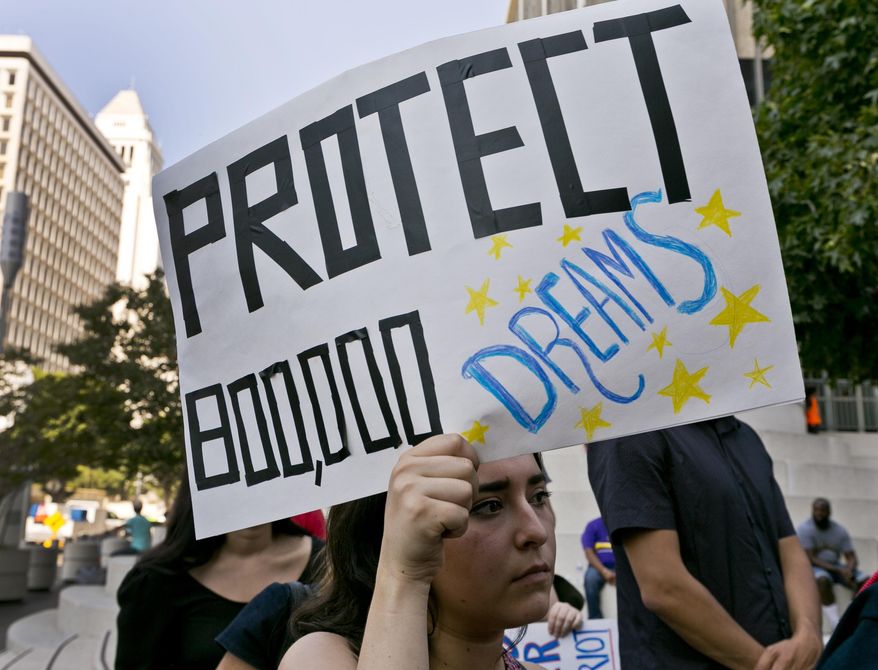FILE - In this Sept. 1, 2017 file photo, a woman joins a rally in support of the Deferred Action for Childhood Arrivals, or DACA program, outside the Edward Roybal Federal Building in downtown Los Angeles Friday, Sept. 1, 2017. California Attorney General Xavier Becerra filed a lawsuit Monday, Sept. 11, against the Trump administration over its decision to end a program that protects young immigrants from deportation who were brought to the U.S. illegally as children or by parents who overstayed visas. (AP Photo/Damian Dovarganes, File)