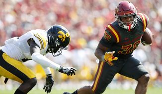 Iowa State running back David Montgomery (32) runs from Iowa defensive back Michael Ojemudia, left, during the second half of an NCAA college football game, Saturday, Sept. 9, 2017, in Ames, Iowa. Iowa won 44-41 in overtime. (AP Photo/Charlie Neibergall)
