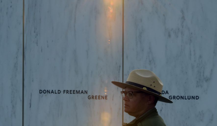A park ranger stands in front of the Wall of Names at the United Flight 93 National Memorial in Shanksville, Pa., Saturday, Sept. 10, 2017. (AP Photo/Fred Vuich)