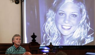 Dana Bobo, let, father of Holly Bobo, testifies in the trial of Zachary Adams as a photo of Holly Bobo is displayed Monday, Sept. 11, 2017, in Savannah, Tenn. Holly Bobo, a 20-year-old nursing student, disappeared from her home in Parsons, Tenn. on April 13, 2011, and Adams is charged with her kidnapping, rape and murder. (AP Photo/Mark Humphrey, Pool)