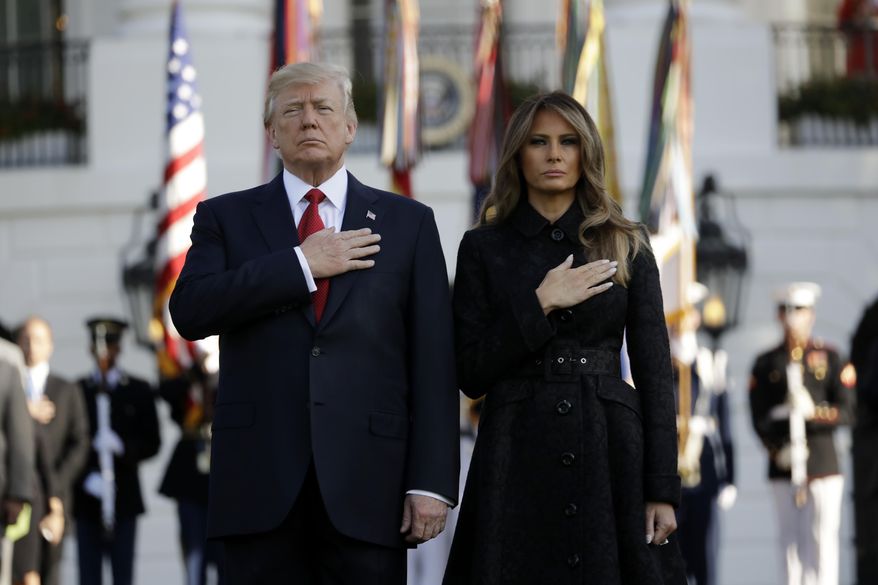 President Donald Trump and first lady Melania Trump stand for a moment of silence to mark the anniversary of the Sept. 11 terrorist attacks, on the South Lawn of the White House, Monday, Sept. 11, 2017, in Washington. (AP Photo/Evan Vucci)