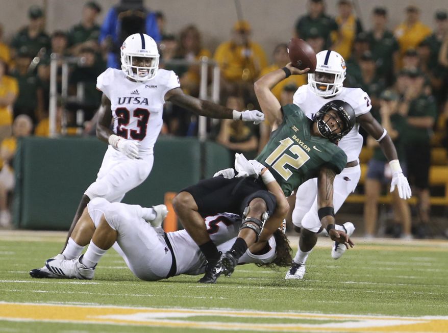 Baylor quarterback Anu Solomon (12) is pulled down by UTSA linebacker Josiah Tauaefa (55) on fourth down during Baylor's final possession in an NCAA college football game, Saturday, Sept. 9, 2017, in Waco, Texas. UTSA won 17-10. (Rod Aydelotte/Waco Tribune Herald, via AP)
