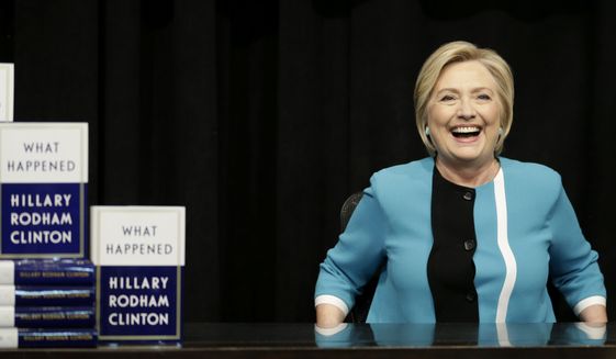 Hillary Rodham Clinton prepares to sign copies of her book &quot;What Happened&quot; at a book store in New York, Tuesday, Sept. 12, 2017. (AP Photo/Seth Wenig)