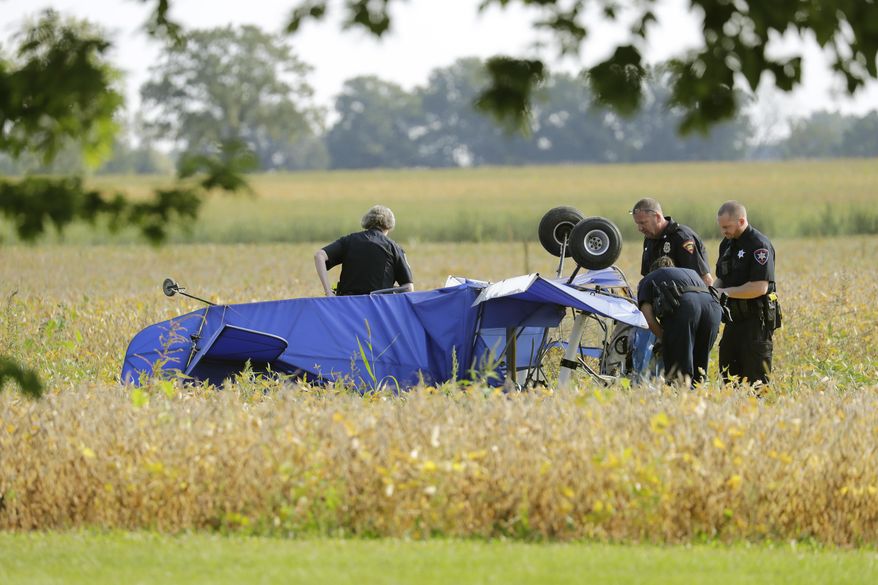 Winnebago County Sheriff's Office officials investigate a plane crash in a field along Winnebago County G near State 76 Tuesday, Sept. 12, 2017, in the Town of Vinland, Wis. According to Capt. Lara Vendola-Messer of the sheriff's department, the sole occupant in the plane, a man, died. (Dan Powers/The Post-Crescent via AP)