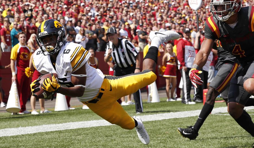 Iowa wide receiver Ihmir Smith-Marsette (6) catches a 15-yard touchdown pass ahead of Iowa State defensive back Evrett Edwards, right, during the second half of an NCAA college football game, Saturday, Sept. 9, 2017, in Ames, Iowa. Iowa won 44-41 in overtime. (AP Photo/Charlie Neibergall)