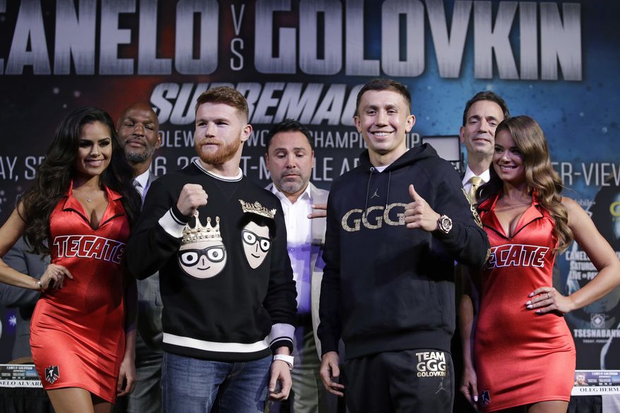 Canelo Alvarez, left, and Gennady Golovkin pose for photographers during a news conference Wednesday, Sept. 13, 2017, in Las Vegas. The two are scheduled to fight in a middleweight title fight Saturday in Las Vegas. (AP Photo/John Locher)