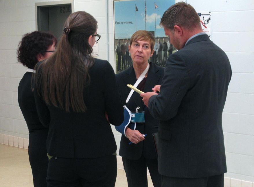Federal public defender Carol Wright, second from right, briefs other attorneys and members of a team representing condemned inmate Gary Otte following Otte's execution on Wednesday, Sept. 13, 2017, in Lucasville, Ohio. Wright, who witnessed the execution, believes Otte's rising and falling stomach indicated he was suffering from a phenomenon known as "air hunger" and she tried unsuccessfully to leave the witness room and alert a federal judge. She said the judge declined to stop the procedure, though it was likely too late at that point. (AP Photo/Andrew Welsh-Huggins)
