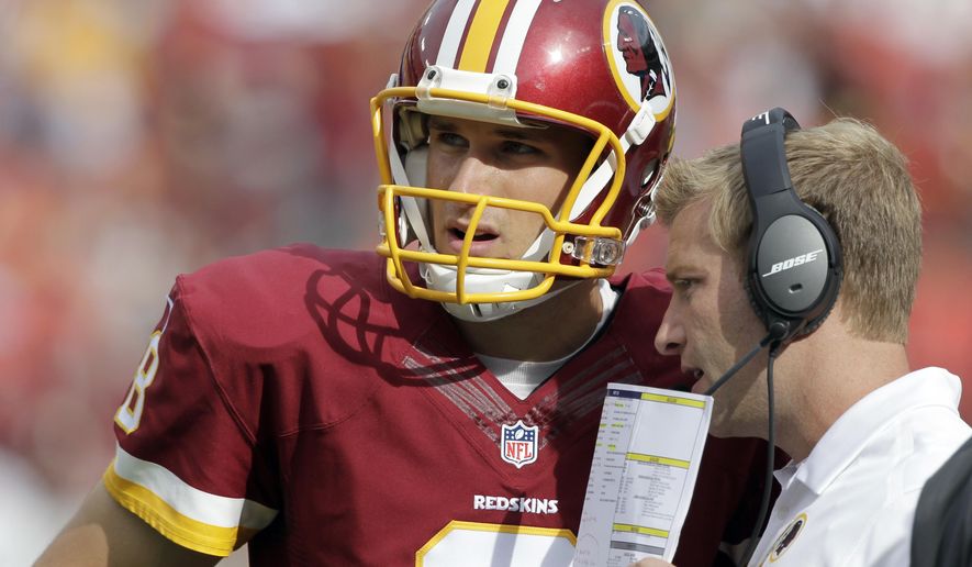 FILE - In this Sunday, Sept. 14, 2014 file photo, Washington Redskins quarterback Kirk Cousins (8) listens to offensive coordinator Sean McVay, during the second half of an NFL football game against the Jacksonville Jaguars in Landover, Md. Redskins quarterback Kirk Cousins will try to rebound from a rough season opener against Sean McVay, his former offensive coordinator who knows him better than most people in the NFL. Cousins on Sunday, Sept. 17, 2017 will face former offensive coordinator Sean McVay’s Los Angeles Rams as the Redskins hope to avoid starting 0-2.  (AP Photo/Mark E. Tenally, File)