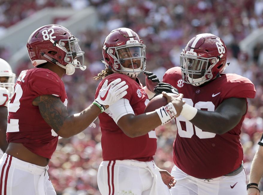 FILE - In this Sept. 9, 2017, file photo, Alabama quarterback Jalen Hurts celebrates after running the ball in for a touchdown in the first half of an NCAA college football game against Fresno State,in Tuscaloosa, Ala. These days, it feels like the only national contender from the SEC resides in Tuscaloosa _ where Alabama has been the conference’s lone representative in each of the first three College Football Playoffs and is the league's only team in this week's Associated Press top 10. (AP Photo/Brynn Anderson, File)