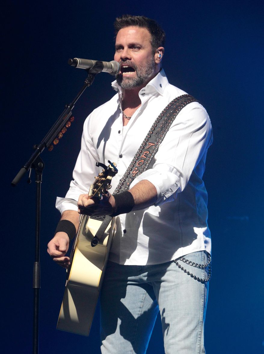 FILE - In this Jan. 17, 2013 file photo, Troy Gentry of the Country Music duo Montgomery Gentry performs on the Rebels On The Run Tour in Lancaster, Pa. Gentry died, Sept. 8, 2017, in a helicopter crash in Medford, N.J. A preliminary report issued Wednesday, Sept. 13, by the National Transportation Safety Board, said engine problems caused a helicopter crash that killed Gentry and the pilot. (Photo by Owen Sweeney/Invision/AP, File)