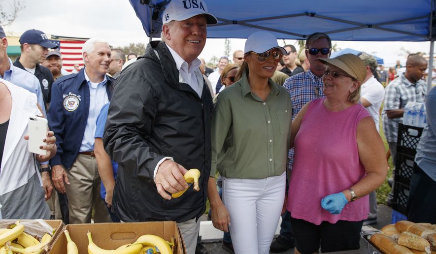 President Donald Trump and first lady Melania Trump, talk and hand out food to people impacted by Hurricane Irma at Naples Estates, Thursday, Sept. 14, 2017, in Naples, Fla. (AP Photo/Evan Vucci)