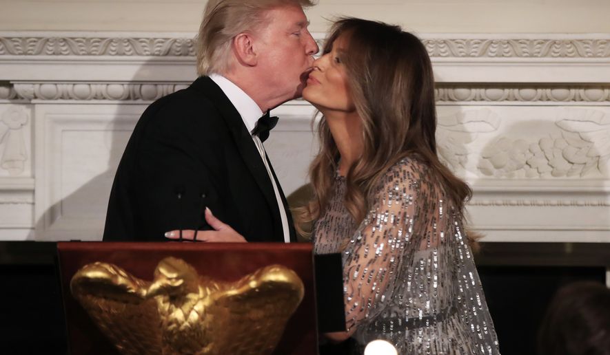 President Donald Trump kisses first lady Melania Trump, after introducing her during the White House Historical Association reception and dinner in the State Dining Room of the White House in Washington, Thursday, Sept. 14, 2017. (AP Photo/Manuel Balce Ceneta)