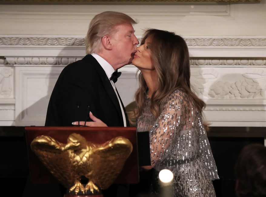 President Donald Trump kisses first lady Melania Trump, after introducing her during the White House Historical Association reception and dinner in the State Dining Room of the White House in Washington, Thursday, Sept. 14, 2017. (AP Photo/Manuel Balce Ceneta)