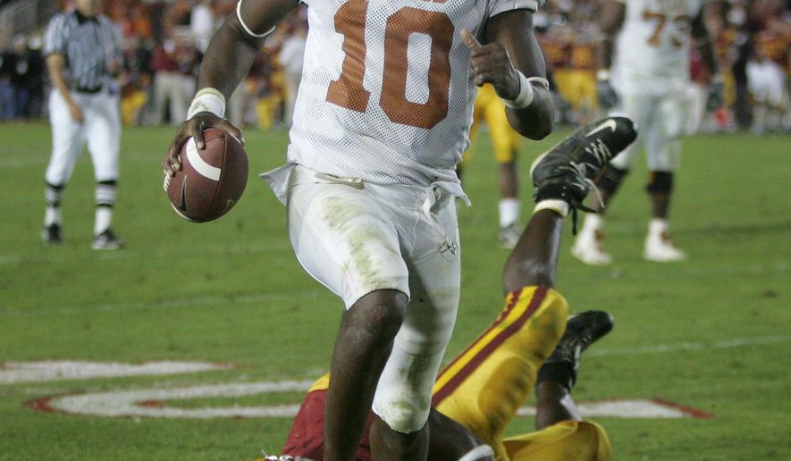 FILE - In this Jan. 4, 2006, file photo, Texas quarterback Vince Young rushes for the game-winning touchdown against Southern California during the Rose Bowl NCAA college football game in Pasadena, Calif. The two teams meet this week for the first time since that Rose Bowl game. (AP Photo/Paul Sakuma, File)
