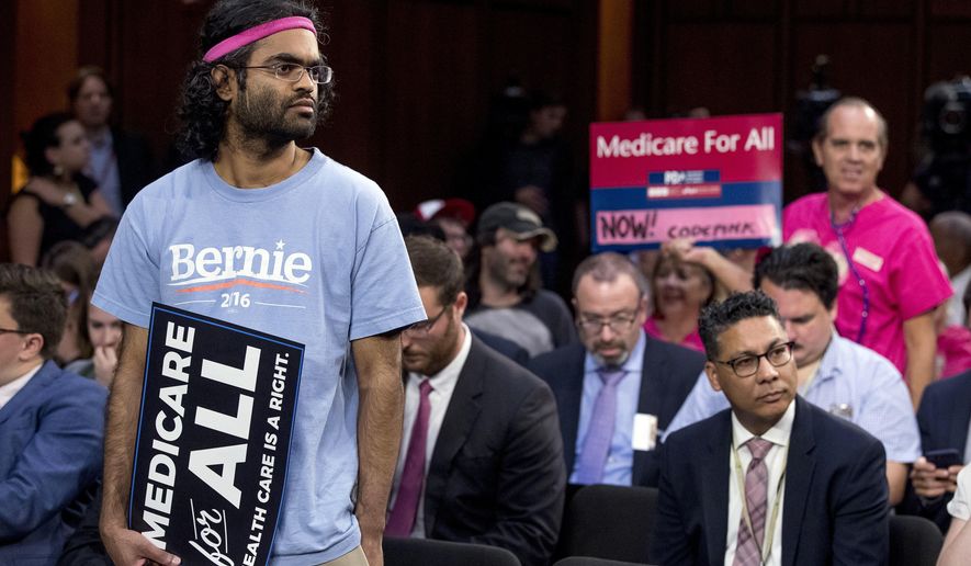 Supporters gather before Sen. Bernie Sanders, I-Vt., and other Democratic senators arrive for a news conference on Capitol Hill in Washington, Wednesday, Sept. 13, 2017, to unveil their Medicare for All legislation to reform health care. (AP Photo/Andrew Harnik)