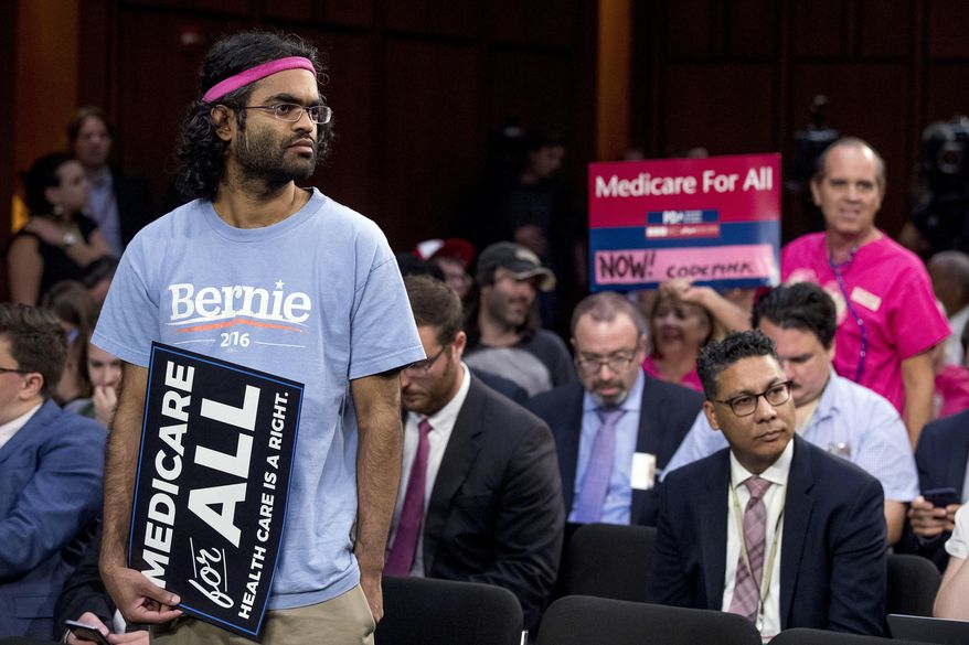 Supporters gather before Sen. Bernie Sanders, I-Vt., and other Democratic senators arrive for a news conference on Capitol Hill in Washington, Wednesday, Sept. 13, 2017, to unveil their Medicare for All legislation to reform health care. (AP Photo/Andrew Harnik)
